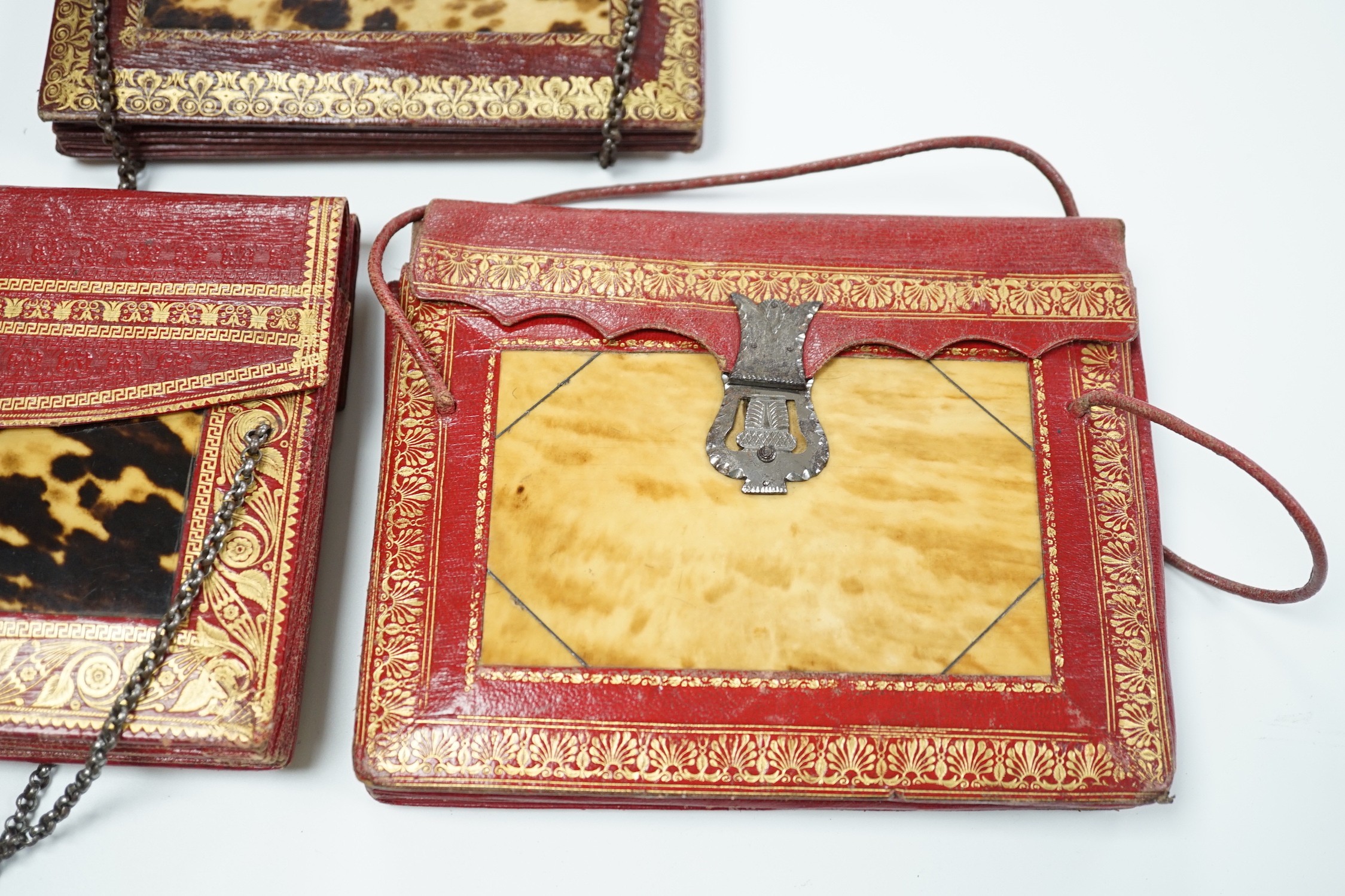 Three rare William IV red and burgundy tooled Moroccan leather and tortoiseshell panelled handbags, two with Scottish thistle shaped cut steel clasps